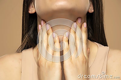 Closeup cropped image of a woman has a thyroid disorder. Sore throat. Inflamed glands Stock Photo