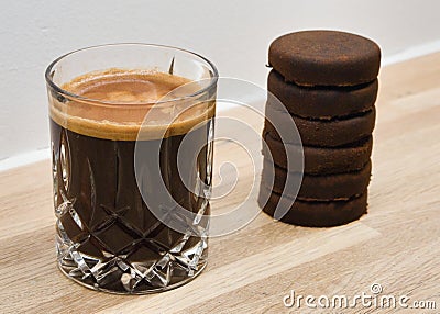 Closeup of a cup of coffee with 6 espresso shots and espresso pucks on the side Stock Photo