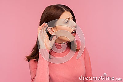 Closeup curious brunette woman holding hand near ear trying to hear secrets and find out gossips, listen to private whispers Stock Photo