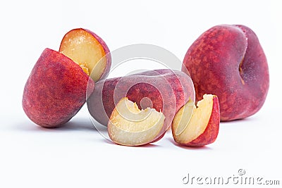 Closeup of cut and whole flat peaches isolated on a white background Stock Photo