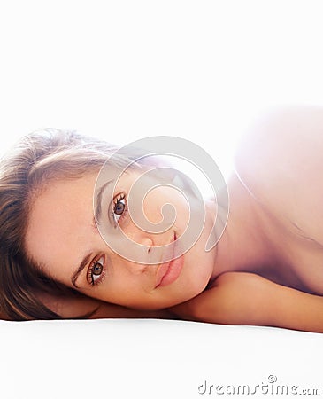 Closeup of a cute female lying topless against white. Closeup of a young cute topless female lying against white Stock Photo