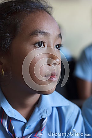 Closeup of a cute girl studying in a class in Kath Editorial Stock Photo