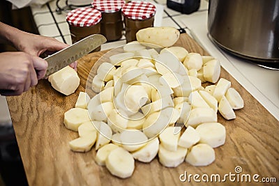 Closeup of cutting potatoes in the kitchen Stock Photo