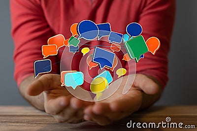 Closeup of 3D rendered digital speech bubbles teamwork connection hovering in man's hands Stock Photo
