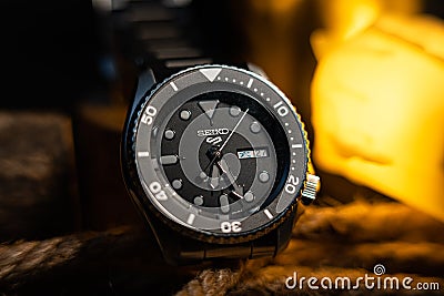 Closeup of a dark and moody Seiko 5 watch on ropes Editorial Stock Photo