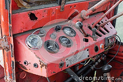 Closeup dashboard gages of old rusty red russian tractor during autumn harvest agriculture technology transportation vehicle Stock Photo