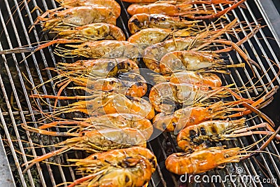 Closeup delicious prawns on charcoal grilled on fire Stock Photo