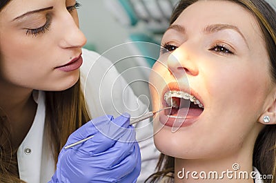 Closeup, dentist checking young woman braces Stock Photo