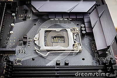 Closeup detail of CPU socket of a modern computer black motherboard. Electronic small component details. Stock Photo