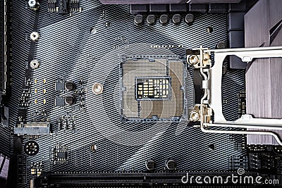 Closeup detail of CPU socket of a modern computer black motherboard. Electronic small component details. Stock Photo