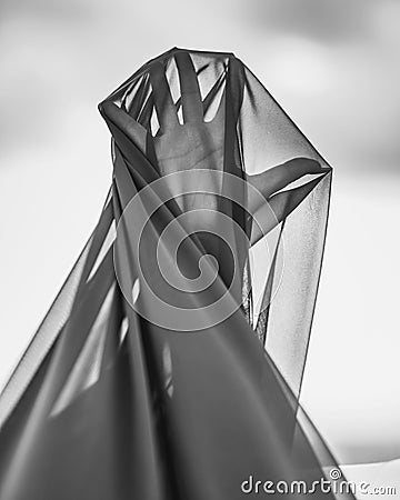 Closeup detail hand of woman under transparent textile Stock Photo