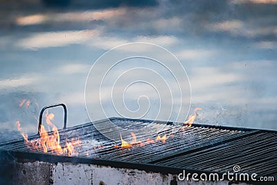 closeup detail of old barbeque grill with fire flames coming out Stock Photo