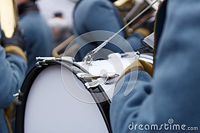 Closeup detail of retro weared standing back soldier drummer with big drum and other soldiers background Stock Photo