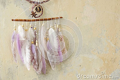 Closeup details modern dreamcatcher with gemstones, crochet doily snowflake, painted feathers, cinnamon stick, star anise Stock Photo