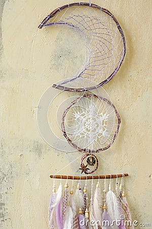 Closeup details modern dreamcatcher with gemstones, crochet doily snowflake, painted feathers, cinnamon stick, star anise Stock Photo