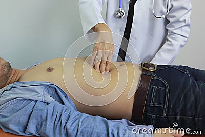 Closeup of Doctor examines or treatment the man abdomen on white background, Health concept Stock Photo