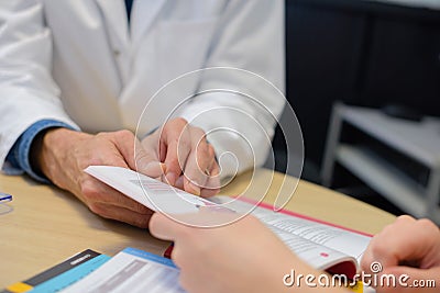 Closeup doctor and patient looking at booklet Stock Photo