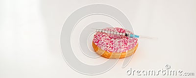 Closeup on donut and diabetes syringe on table Stock Photo