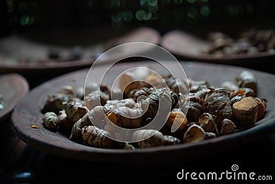 Closeup dried galangal on the clay plate Stock Photo