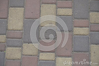 Closeup of dusty brown, yellow and pink colored concrete pavers Stock Photo