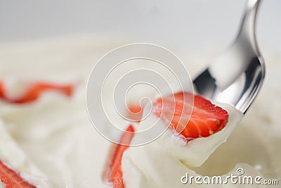 Closeup of eating fresh chopped strawberries with white yogurt Stock Photo