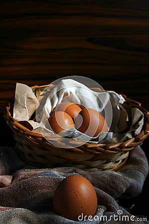 Egg up close. Egg basket on fabric. Wooden background Stock Photo