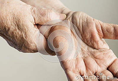 Closeup of elderly hands checking pulse Stock Photo