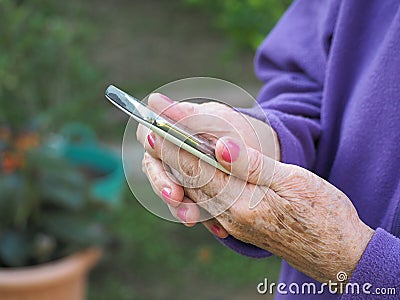 Closeup of elderly woman hands holding mobile phone Stock Photo