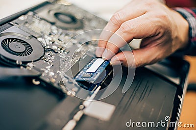 Closeup of electrical engineer technician changing memory in laptop computer Stock Photo