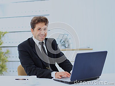 Closeup of employee in the office working on laptop computer. Stock Photo