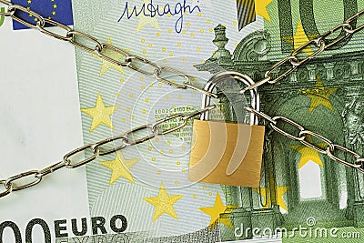 Closeup of 100 euro banknote locked with chain and padlock - Concept of insurance, bail-in and financial security Stock Photo
