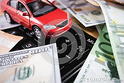 Closeup euro, dollars banknotes with red car on the calculator Stock Photo