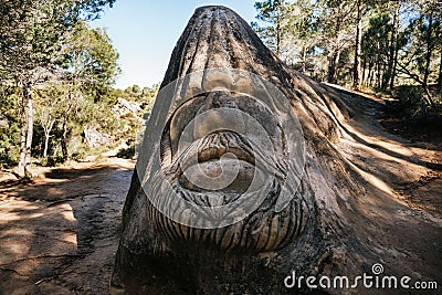 Closeup of a face carved in stone at Ruta de las Caras in Buendia, Cuenca, Spain Editorial Stock Photo