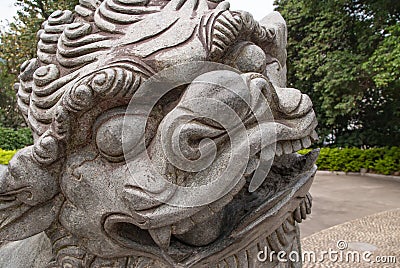 Closeup of face of Chinese mythological lion in Seven Star Park, Guilin, China Stock Photo