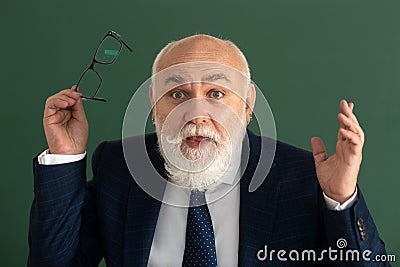 Closeup face of excited professor or surprised teacher on blackboard isolated. Stock Photo