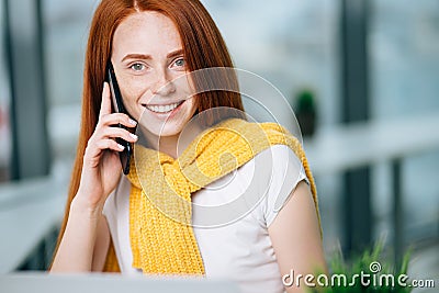 Closeup facial portrait of happy redhead woman on mobile phone call Stock Photo