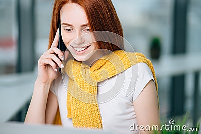 Closeup facial portrait of happy redhead woman on mobile phone call Stock Photo