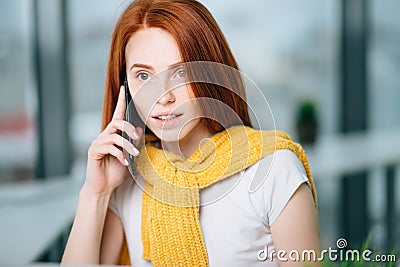 Closeup facial portrait of happy redhead woman on mobile phone call Stock Photo