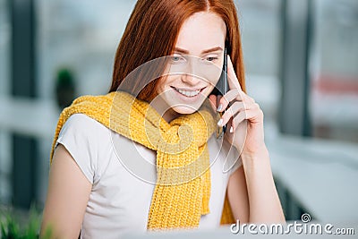 Closeup facial portrait of happy redhead woman on mobile phone call Stock Photo