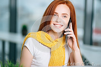 Closeup facial portrait of happy redhead woman on mobile phone call Stock Photo