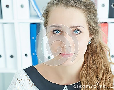 Closeup facial portrait of young attractive Caucasian secretary on office background. Stock Photo