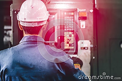 Closeup factory worker man operate the machine, high skill labor work industry with safety clothes Stock Photo