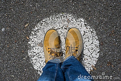 feet standing on the road on painted circle - Social Distancing concept Stock Photo