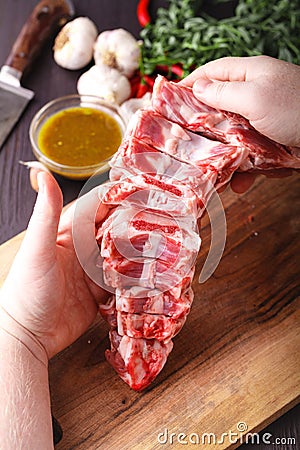 Closeup of female butcher`s hands holding meat piece Stock Photo