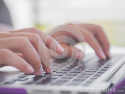 Closeup female hands typing on laptop keyboard. Stock Photo