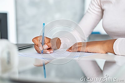 Closeup female hands during writing with pen on a paper Stock Photo