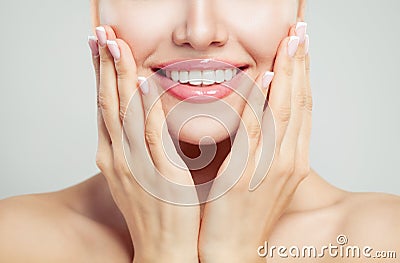 Closeup female smile and manicured hand. French manicure, white teeth and pink glossy lips makeup Stock Photo