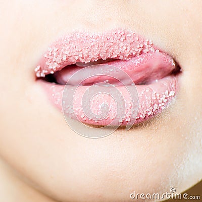 Closeup on female sweet sugary lips with licking tongue Stock Photo