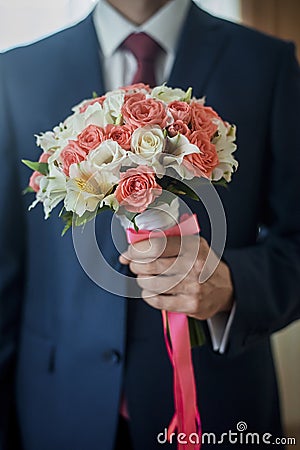 Closeup of a fiance in suit with wedding flowers Stock Photo