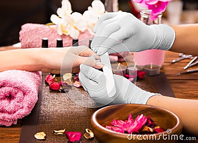 Closeup finger nail care by manicure specialist in beauty salon. Stock Photo